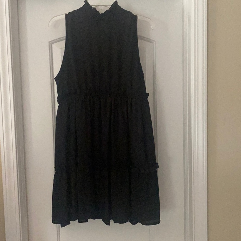 Black mock neck dress with back button closure. Length is just above the knee.